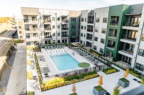 Memphis apartment for rent - A swimming pool is surrounded by apartment buildings at Harbor Side at Conwood Flats Apartments, Memphis, TN, 38107