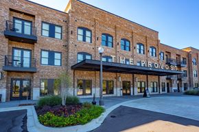 Southaven apartment for rent - The Proviso building has a brick facade and a landscaped courtyard in front.