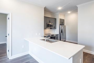 Southaven apartment for rent - A kitchen with a white counter top and stainless steel appliances.