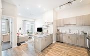 Savannah apartment for rent - a kitchen and living room with wood floors and white walls at The Baxly, Savannah, GA, Georgia , 31401