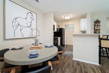 Chattanooga apartment for rent - a dining room area with a table and chairs and a living room with a kitchen