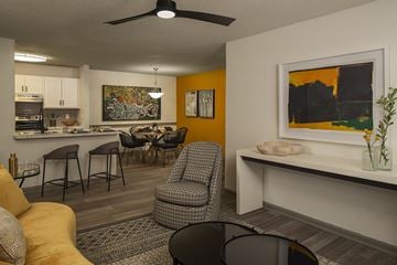 Union City apartment for rent - A living room with a yellow couch and a grey chair.