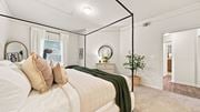 Cordova apartment for rent - A bedroom with a large bed and a mirror on the wall.