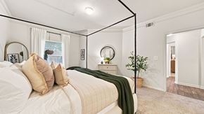 Cordova apartment for rent - A bedroom with a large bed and a mirror on the wall.