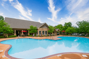 Overland Park apartment for rent - A large swimming pool in front of a house.