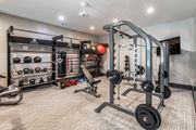 Evans apartment for rent - A well-equipped home gym with a variety of exercise equipment at Ansley at Town Center Apartments, Evans, GA