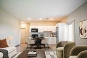 Memphis apartment for rent - A modern living room with a dining area and kitchen in the background.