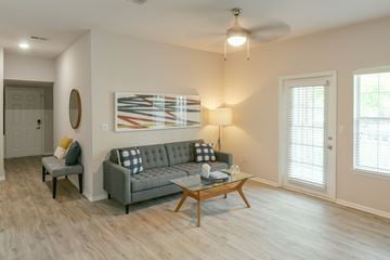 Overland Park apartment for rent - A living room with a grey couch and a coffee table.