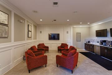 Germantown apartment for rent - A living room with red chairs and a television.