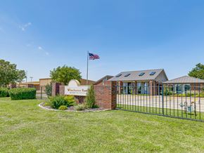 Oklahoma City apartment for rent - The image shows a building with a sign that reads "Winchester Run" in front of it.