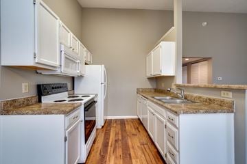 Centerville apartment for rent - A kitchen with white cabinets and a granite countertop.
