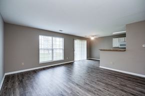 Centerville apartment for rent - A spacious room with wooden flooring and a window with blinds.