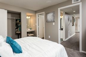 Georgetown apartment for rent - A bedroom with a white bed and a blue pillow.