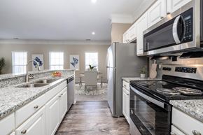 Wexford townhouse for rent - a kitchen with stainless steel appliances and granite counter tops