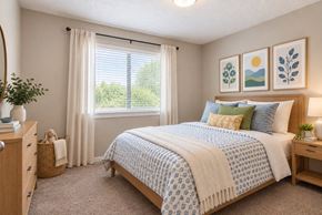 Gaffney apartment for rent - A bedroom with a large bed and a window with curtains.