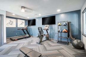Gaffney apartment for rent - A gym room with a treadmill, exercise bike, and other equipment.