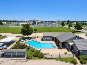 Oklahoma City apartment for rent - A large building with a pool in front.
