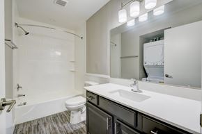 Bethany apartment for rent - A white toilet sits in a white bathroom next to a sink.