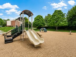 Georgetown apartment for rent - A playground with a slide, a climbing structure, and a swing set.