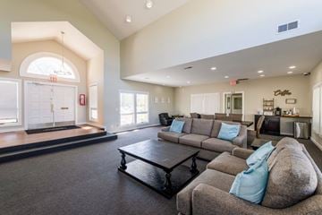 Dayton apartment for rent - A spacious living room with a grey sofa and a black coffee table.