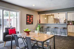 Indianapolis apartment for rent - A dining room with a table set for two and a view of the backyard.