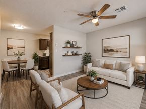 Oklahoma City apartment for rent - A living room with a white couch, a wooden coffee table, and a ceiling fan.