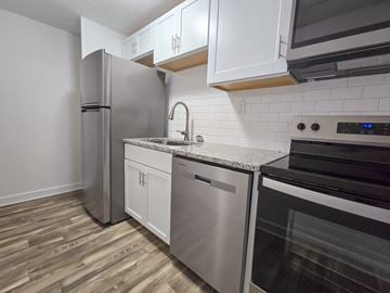 Gainesville apartment for rent - A kitchen with a refrigerator, dishwasher, and oven.