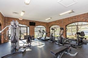 Manchester apartment for rent - A gym with a variety of equipment including treadmills, stationary bikes, and weight machines.