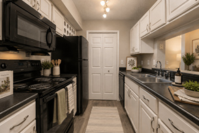 Columbia apartment for rent - A kitchen with black appliances and white cabinets.