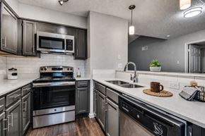 Bedford townhouse for rent - A modern kitchen with a stainless steel oven and microwave.