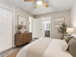 Oklahoma City apartment for rent - A bedroom with a large bed and a wooden dresser.