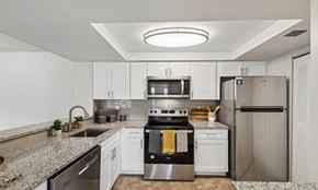 West Palm Beach apartment for rent - A modern kitchen with stainless steel appliances and granite countertops.