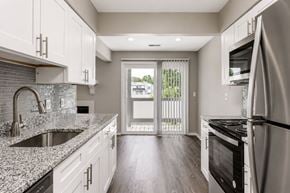 Indianapolis townhouse for rent - A modern kitchen with white cabinets and a stainless steel refrigerator.
