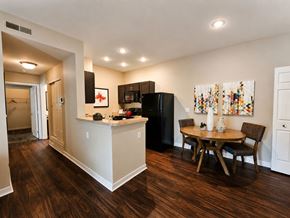 Columbus townhouse for rent - A kitchen with a black refrigerator and wooden floors.
