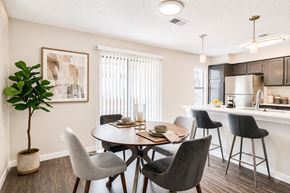 Bedford townhouse for rent - A dining room with a round table and chairs.