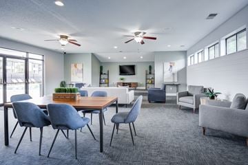 Indianapolis townhouse for rent - A modern living room with a dining table and grey chairs.