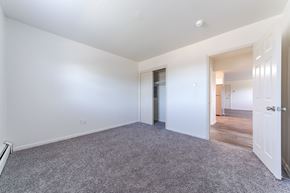 Lansdale apartment for rent - A spacious room with a grey carpet and white walls.
