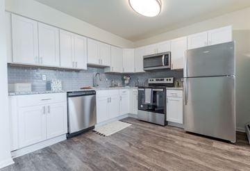 Lansdale apartment for rent - A kitchen with white cabinets and stainless steel appliances.