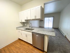 Wyoming apartment for rent - A kitchen with white cabinets and a granite countertop.