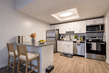 Louisville apartment for rent - A kitchen with a white counter and stainless steel appliances.