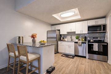 Zelienople townhouse for rent - A kitchen with a counter and a chair.