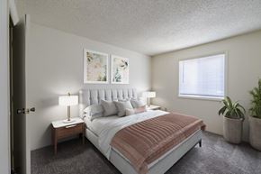 Fayetteville apartment for rent - A bedroom with a large bed and a window.
