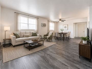 Lansdale apartment for rent - A living room with a white couch, a coffee table, and a dining table with chairs.