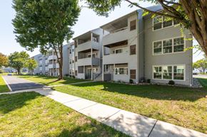 Dover apartment for rent - Apartment building with a sidewalk and trees in front.