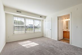 Dover apartment for rent - A spacious room with a large window and a door leading to another room.