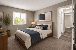 Indianapolis townhouse for rent - A bedroom with a bed, nightstand, and window.