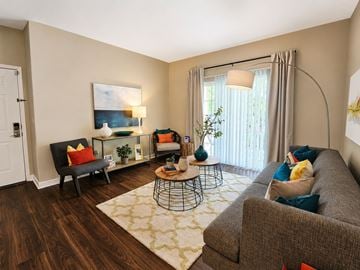 Columbus townhouse for rent - A living room with a grey couch, a black chair, a coffee table, and a painting on the wall.
