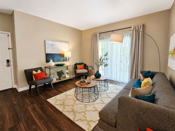 Columbus townhouse for rent - A living room with a grey couch, a black chair, a coffee table, and a painting on the wall.