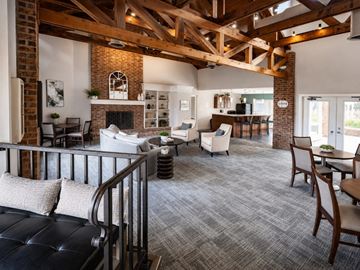 Fort Wayne townhouse for rent - A living room with a black leather ottoman and a grey carpet.