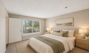 West Palm Beach apartment for rent - A bedroom with a large bed and a painting on the wall.